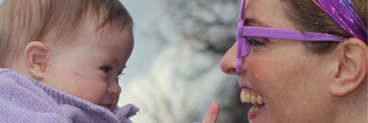 On Bonding With My Daughter With Down Syndrome A mom smiling at her toddler with Down syndrome