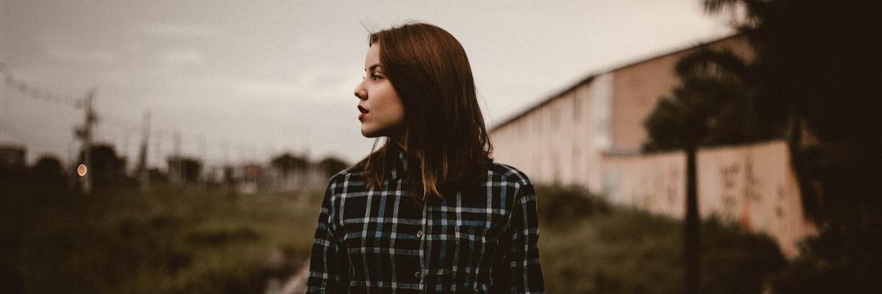 We Need a Cure for Trigeminal Neuralgia Woman standing on train tracks looking over to the side