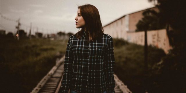 We Need a Cure for Trigeminal Neuralgia Woman standing on train tracks looking over to the side