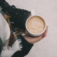 Woman holding a cup of hot cocoa.