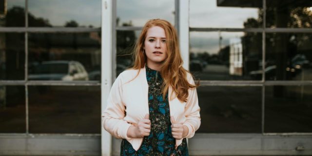 Electroconvulsive Therapy Traded My Memories for My Life (and I'd Do It Again) Young woman in a dress and cardigan standing outside, contemplative expression