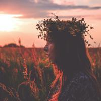 photo of a woman at sunset in a field wearing a flower headdress