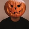 photo of a man wearing a jack o lantern pumpkin head