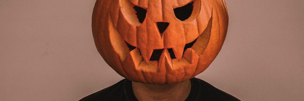 Realizing I Lost Years of My Life Because of Alcohol Addiction photo of a man wearing a jack o lantern pumpkin head