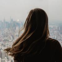photo of a woman from behind looking out over New York City