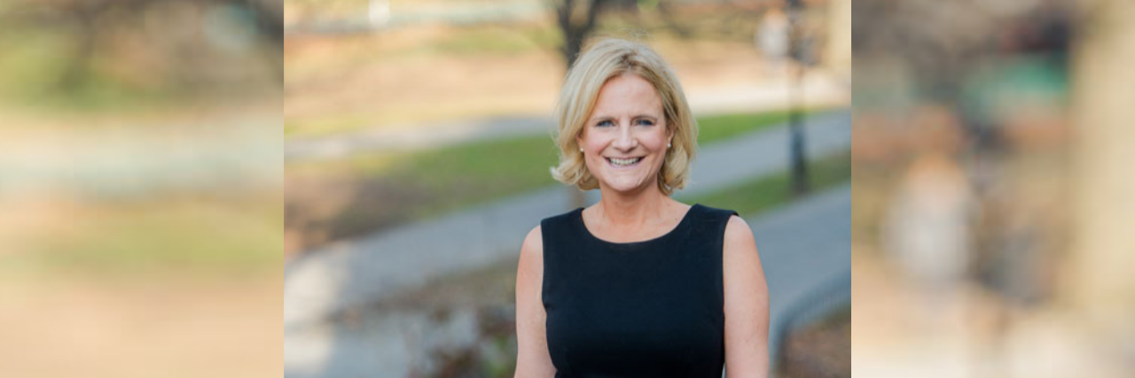 When People Say, 'I Don’t See You as Disabled' Ruth standing outdoors. Her left hand has a limb difference including missing fingers.