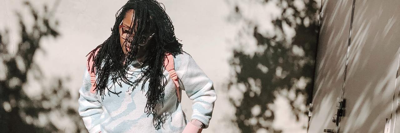 The Struggle of Seeing Therapists Who Have Privilege In Areas I’ve Been Oppressed photo of a woman standing in street with hands in pockets