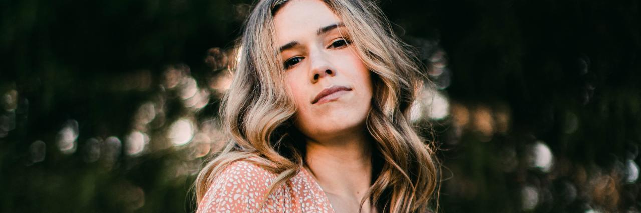 A Therapist Used My Borderline Personality Disorder to Dismiss Rape photo of a woman looking into the camera with a serious expression