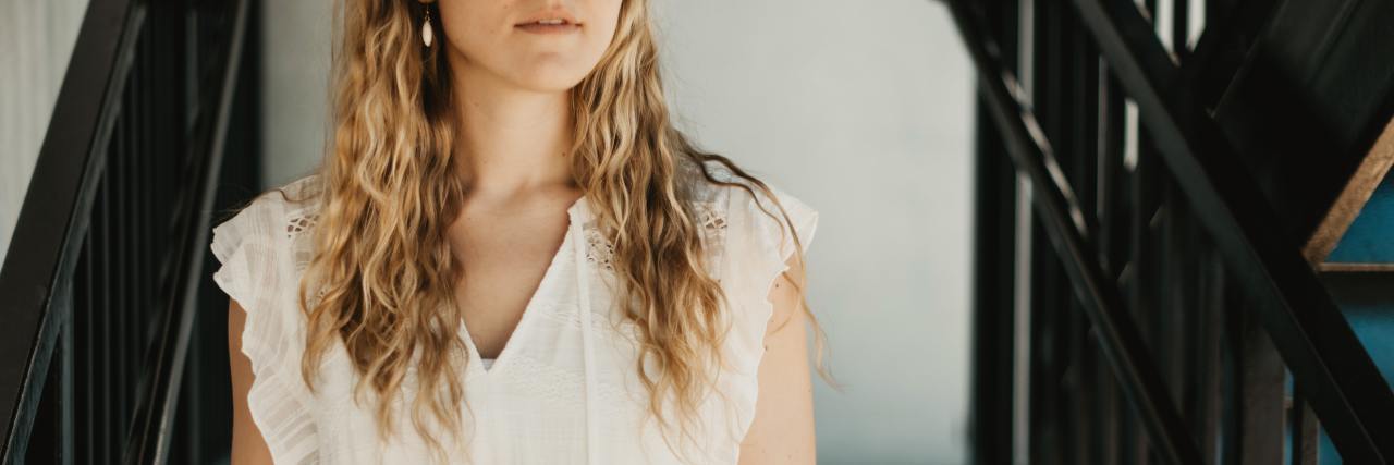 Britney Spears' Relatable Fear of Freedom After Abuse and Control photo of a young woman close up as she stands on stairs