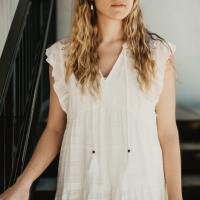 photo of a young woman close up as she stands on stairs