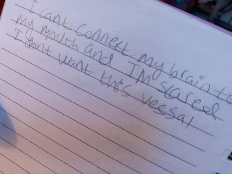 Nera's notebook with messages written while non-verbal. This entry reads: "I can't connect my brain to my mouth and I'm scared I don't want this vessal."