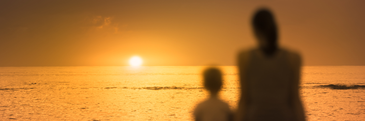 Losing and Finding Myself Amidst Motherhood a mother and a son watching the sunset