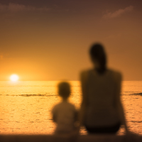 a mother and a son watching the sunset