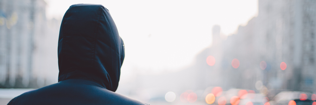 How My Father's Battle With Addiction Affected Me Back of a man in a rain jacket walking down a foggy city street