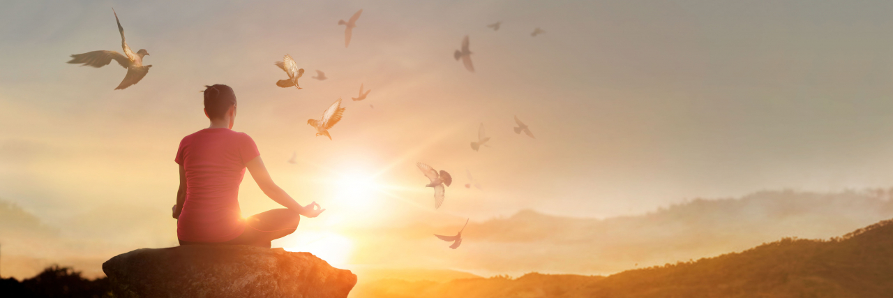 Molar Pregnancy, Cancer and the Miscarriage That Never Ends A woman practicing yoga on a mountain with the sunset