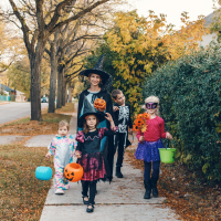 Mother with children going to trick or treat on Halloween