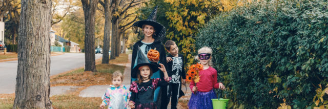 Mother with children going to trick or treat on Halloween