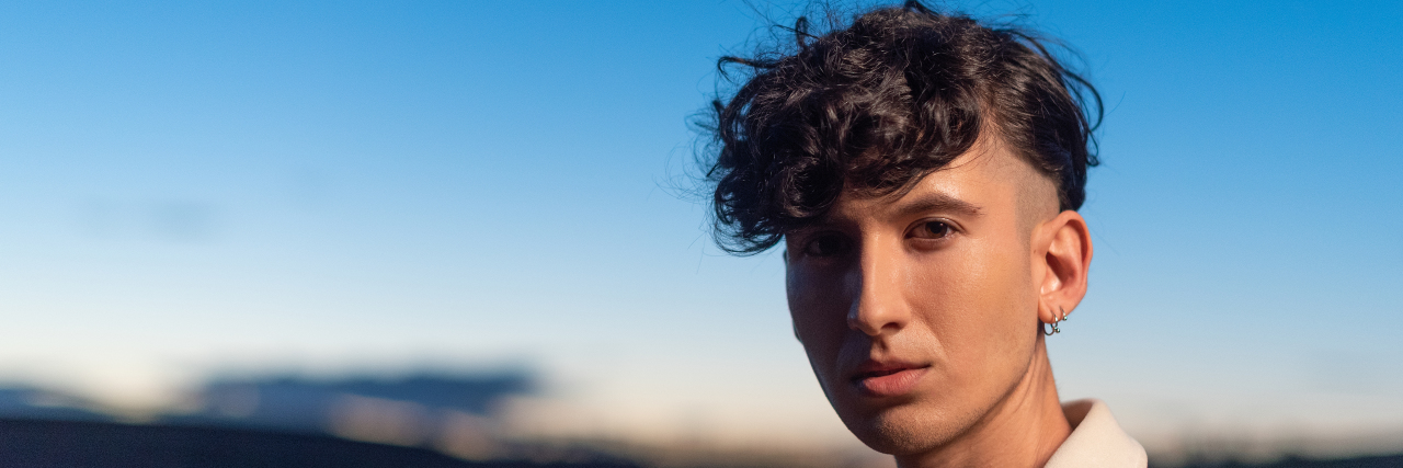 How My Hysterectomy Helped Affirm My Gender Identity Genderqueer person outdoors at sunset.