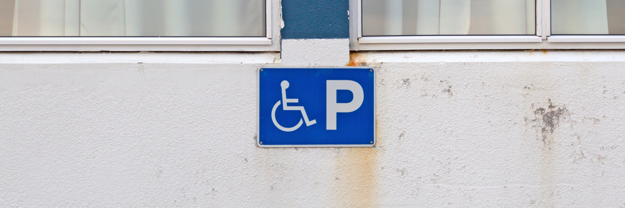 Blue disability parking sign for disabled drivers.