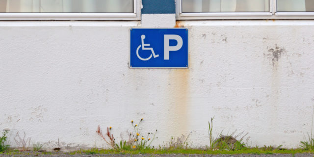 Blue disability parking sign for disabled drivers.