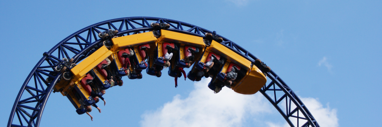 How Understanding Good Pain & Bad Pain Helps Me Live With Chronic Pain People hanging upside down on the roller coaster track.