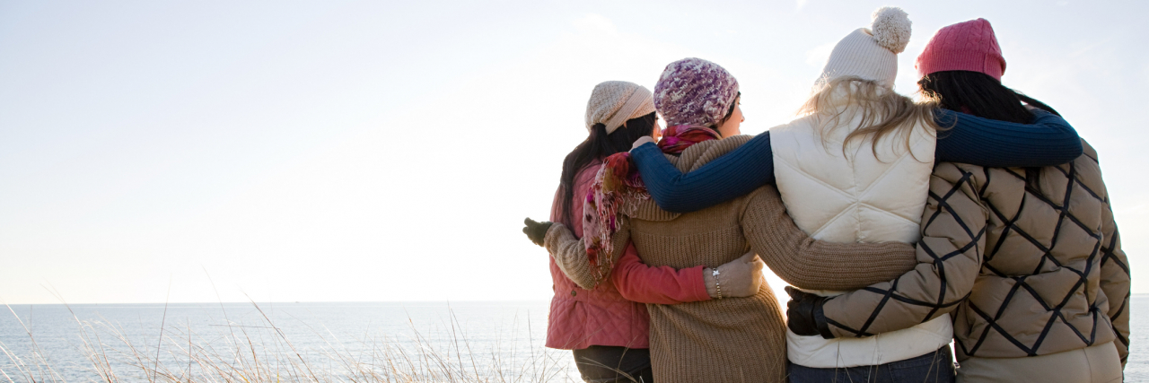 How My Loved Ones Supported Me Through Divorce When I Was Manic Group of women with their backs to the camera standing outside with arms wrapped around each other
