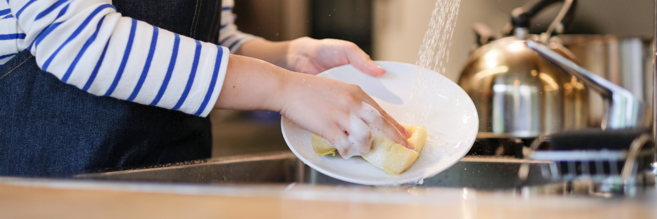 What It's Like to Work as Someone With an Intellectual Disability Woman washing dishes in the kitchen of restaurant.