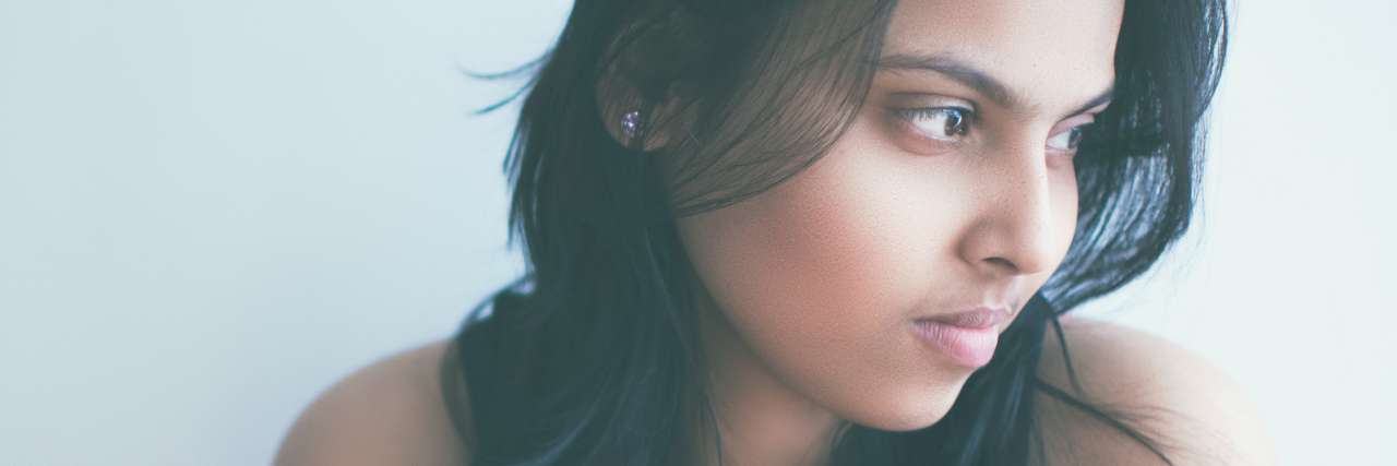 What's Actually Wrong With Telling Someone 'It Could Be Worse' photo of a young Indian person looking away from camera