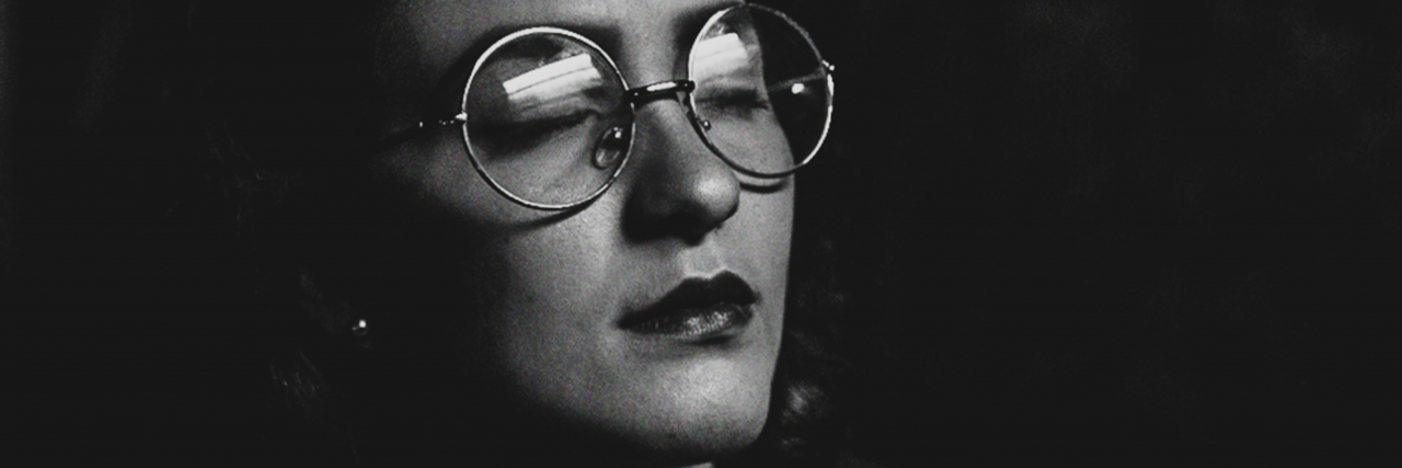 What Is Autonomic Hyperarousal: Chronic Nightmares With PTSD black and white photo of a woman with her eyes closed and wearing glasses