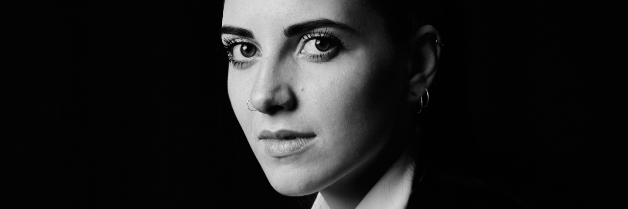 COVID-19 Showed Me That Eating Disorder Recovery Isn't Linear black and white photo of a woman with short hair looking at the camera with serious expression