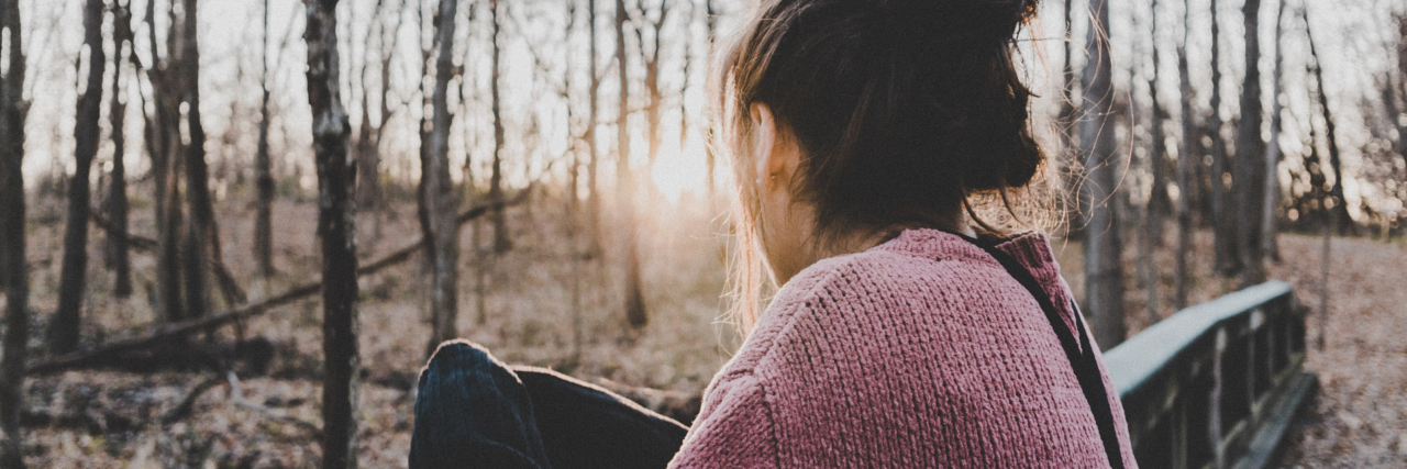 Mental Health: My Experience As the 'Troubled Roommate' at College photo of a young woman looking out over forest