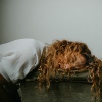 A woman with her head rested on a pillow