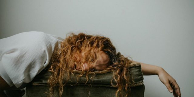 A woman with her head rested on a pillow