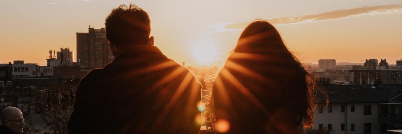 People With Bipolar Disorder Want You to Know This About Their Lives photo of people silhouetted against a sunset or sunrise