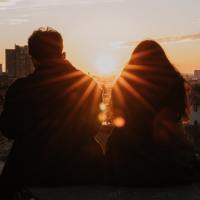 photo of people silhouetted against a sunset or sunrise