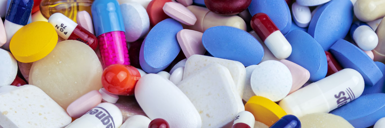 Frame of photo filled with pile of pills in different colors and shapes