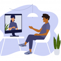 Man sitting on chair at home and talking to therapist on computer screen.