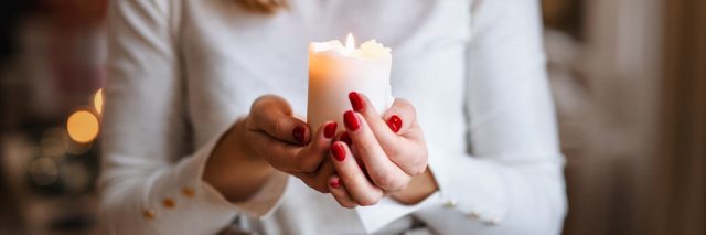 Woman holding holiday candle