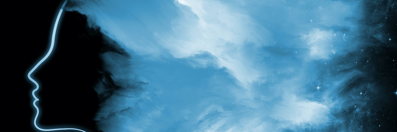 Understanding What an Emotional Flashback Means With PTSD Profile of person's face on black background, fading into light blue smoke and stars