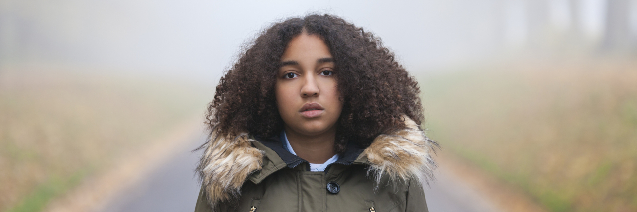 The 'Hidden' Nature of Childhood Emotional Abuse Outdoor portrait of young woman of color outside in a park on foggy day
