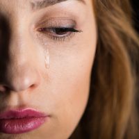 Close-up view of young crying woman's face