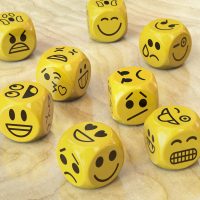 Many yellow dice with emoji or emoticon faces.