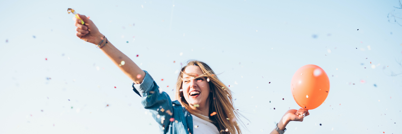 This Balloon Visualization for New Year's Eve Helps My Mental Health Woman holding balloon