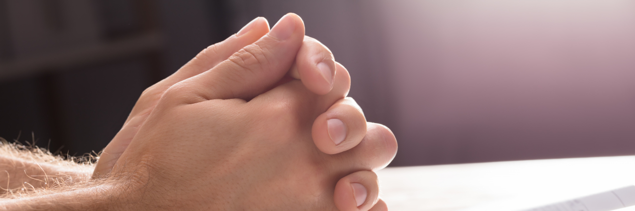 Close-up Of Man's Praying Hands.