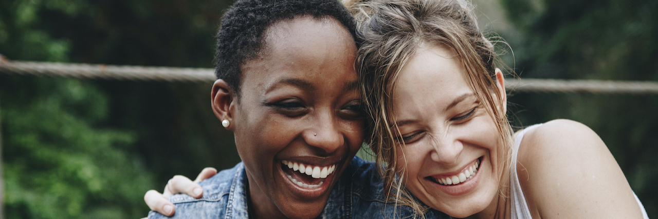 I Miss You and I'm Sorry My PTSD Ended Our Friendship Two friends holding each other and laughing