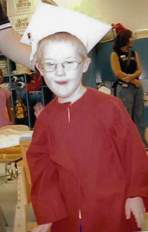 AJ as a young child in cap and gown.