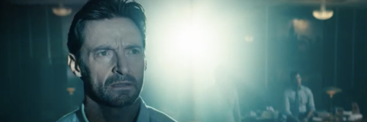 2021 Recap: How These 6 Movies Portrayed Grief and Loss Hugh Jackman with a serious expression looking at something