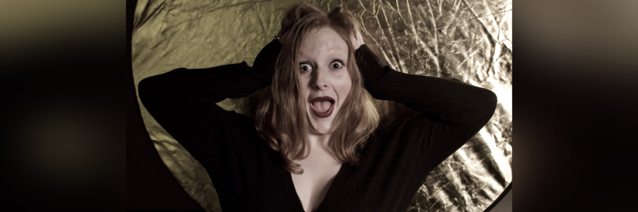 Revealing My Authentic Self As Someone With Chronic Illness Contributor holding her head with mouth and eyes wide open in surprise
