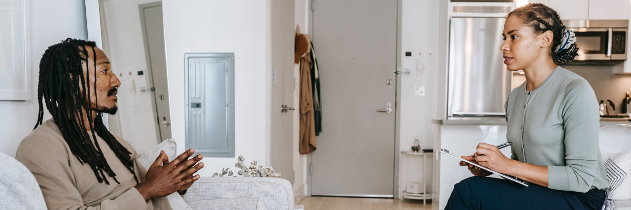 5 Stereotypes About Therapists That Further the Mental Health Epidemic Black man sitting on a couch with a therapist