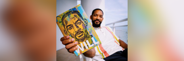 Will Smith holding a copy of his book "Will" sitting on a porch with blue sky in the background